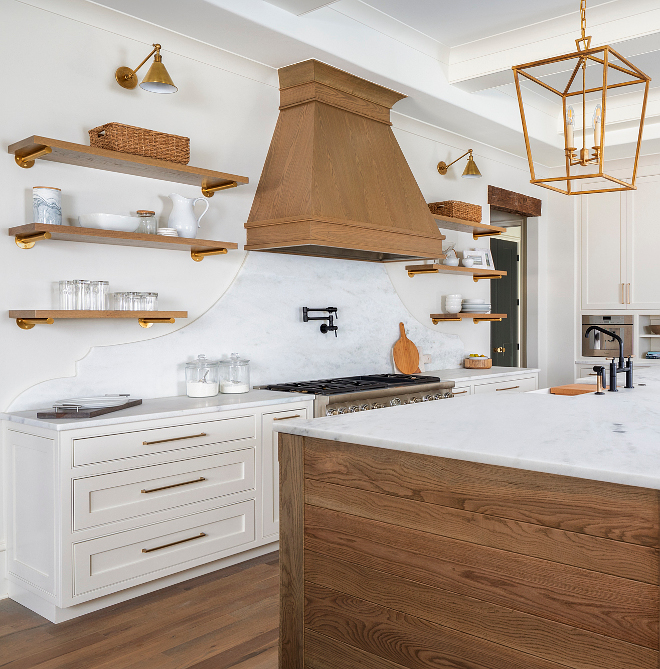 Kitchen Floating Shelves over Marble Slab Backsplash The same super white Carrera Marble that blankets the countertops heads up the wall making for what is just about worthy of being called a piece of art! We flanked it with the open shelving to soften the space #marbleslab #slabBacksplash #Kitchen #FloatingShelves #MarbleSlabBacksplash