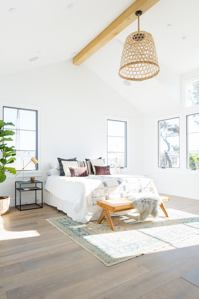 Modern Farmhouse Bedroom with black windows I love the architectural details of this master bedroom Notice the White Oak beam and the vaulted ceilings #ModernFarmhouseBedroom #blackwindows #whiteoakbeam #vaultedceiling