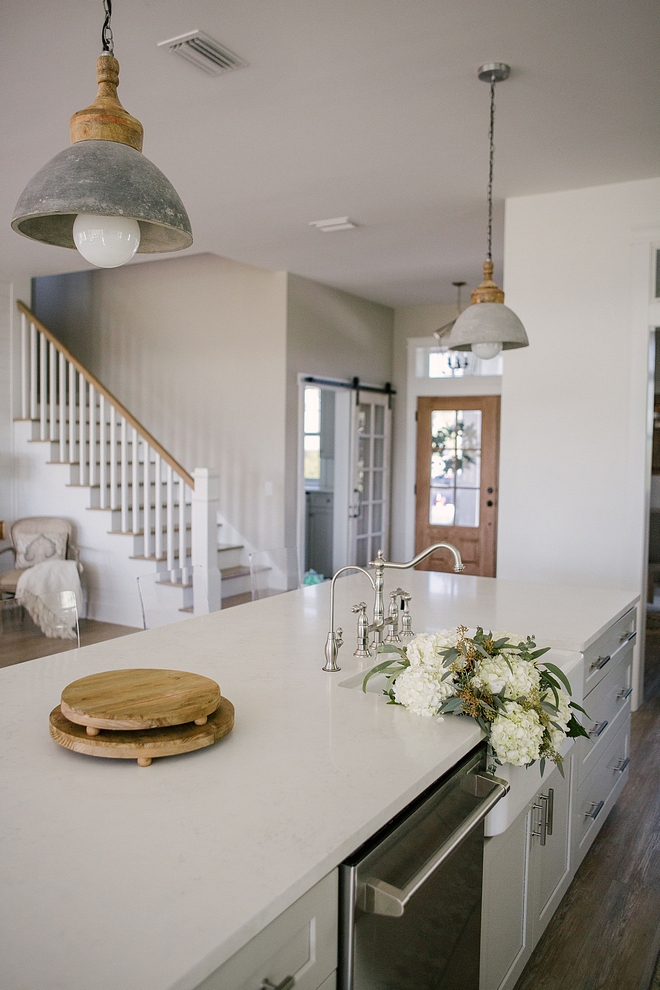 The kitchen island features the same quartz countertop, Snow Point Kitchen island quartz countertop #kitchen #kitchenisland #quartzcountertop