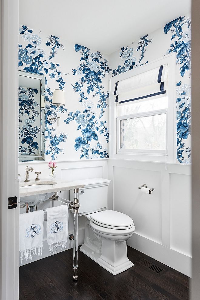 Powder Bathroom Powder Bath features classic wainscoting, blue and white floral wallpaper, acrylic bathroom basin and a dramatic dark hardwood flooring #PowderBathroom #PowderBath #Bathroom #wainscoting #wallpaper