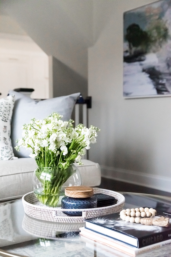 A woven tray brings some texture to this glass coffee table