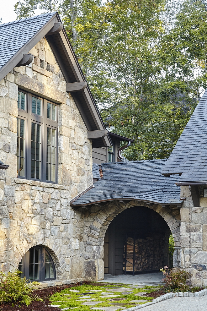 Arched breezeway Stone breezeway An arched breezeway between the garage and mudroom door adds character to this classic rustic lakeside home #archedbreezeway #breezeway #stonebreezeway