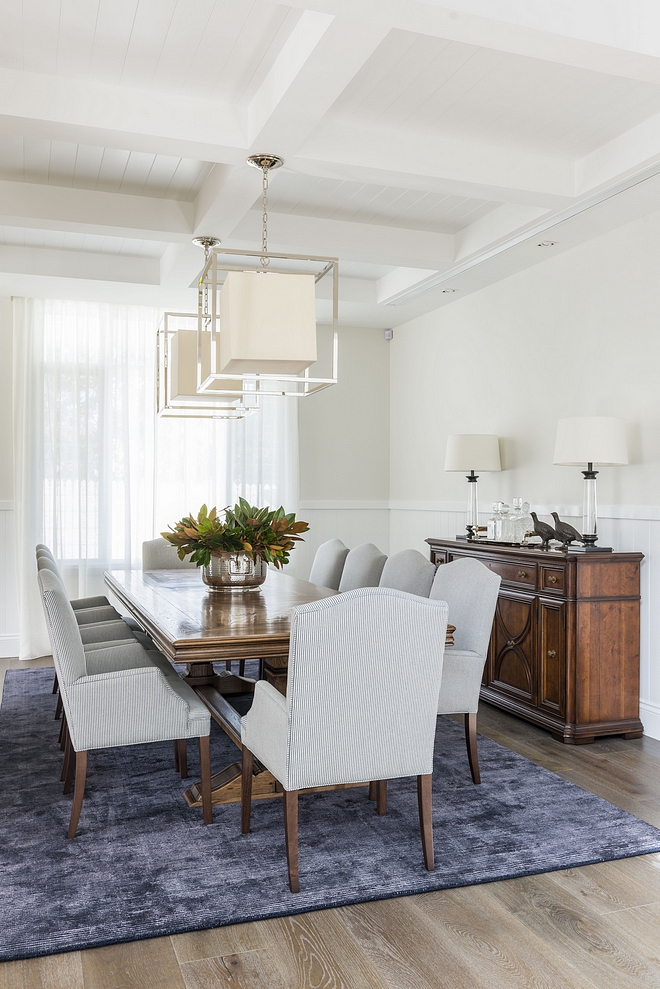 Traditional Dining Room featuring coffered ceiling with tongue and groove, White Oak hardwood floring, chair rail wall trim and a pair of caged lantern pendant lights #diningroom #traditionalinterior #diningrooms