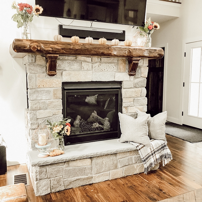 Log Mantel A custom log mantel adds a rustic feel to this stone fireplace #log #logmantel #mantel