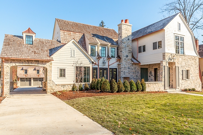 Stone Exterior The exterior layers materials such as stone, siding, cedar shake and copper accents The charming porte cochere features a cupola and serves as an entry point to the two story detached garage Stone Exterior #StoneExterior #Exterior #portecochere #stone #siding