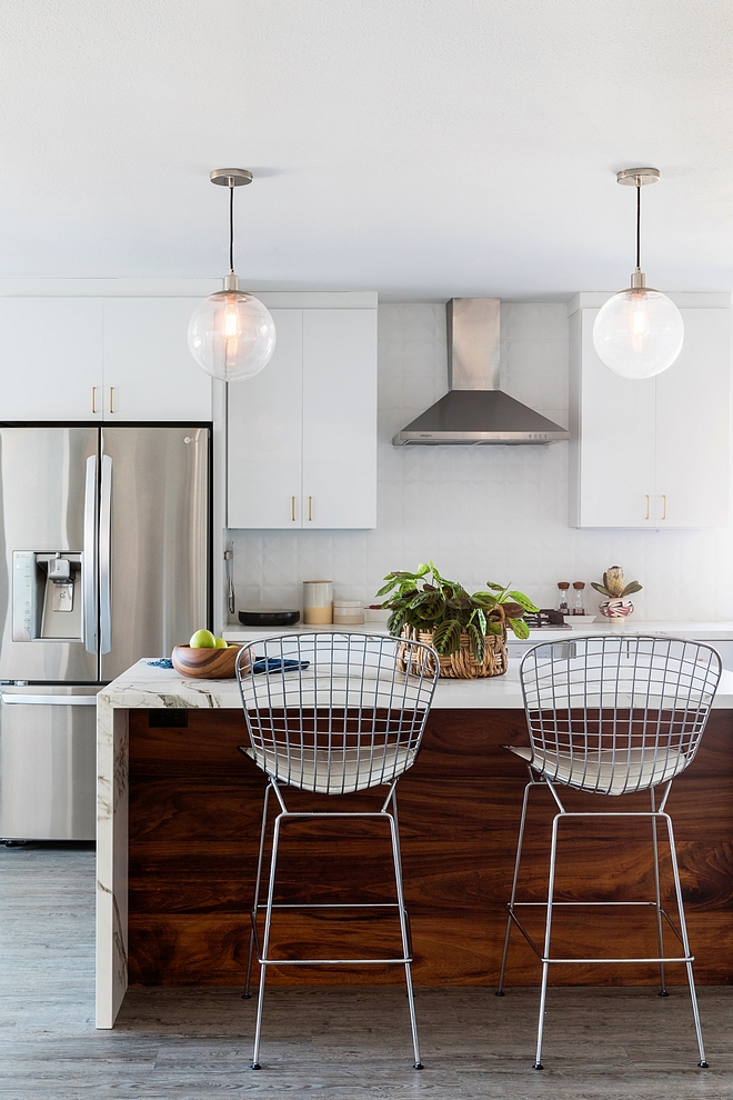 Kitchen island with white marble waterfall countertop and Walnut paneling to add warmth to this white kitchen #Walnut #Walnutshiplap #shiplap #whitekitchen #waterfallcountertop #waterfallisland #waterfallkitchen #kitchen