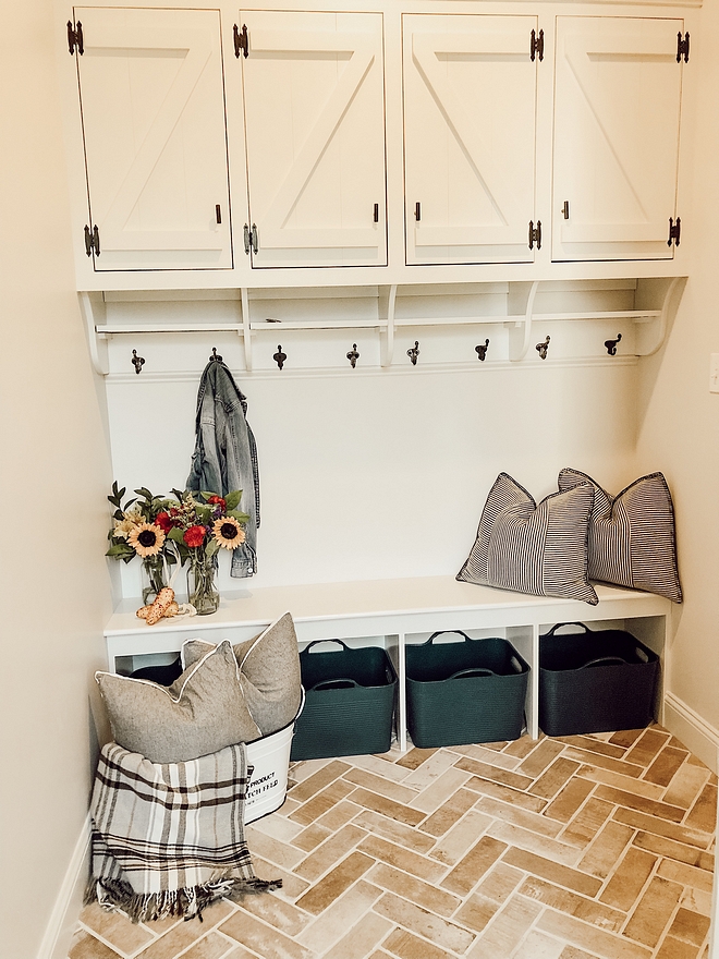 Mudroom Mudroom with dark hardware against the off-white cabinet and the herringbone brick flooring #Mudroom #Mudroomcabinet Mudroomflooring #herringbone #brickflooring #herringbonebrick #herringbonebrickflooring