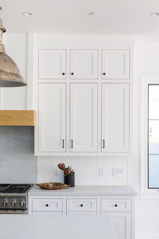 Backsplash Solid slab of honed Carrera marble to match the countertops behind the range and v-groove paneling on both sides rather than tile #backsplash #vgroove #backsplashpaneling #paneling