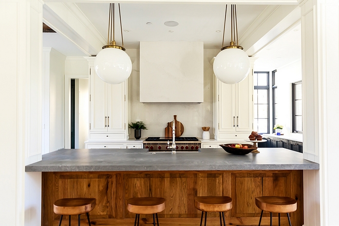 Kitchen Wolf range, Shaws fireclay farmhouse sink and an expansive island makes this a home-cook's dream kitchen Walls are Benjamin Moore White Dove #kitchen #BenjaminMooreWhiteDove #kitchenpaintcolor #kitchens #kitchendesign #kitchenproject #kitchenreno #whitekitchenpaintcolor #whitekitchen #kitchenisland #woodcabinet #kitchenwoodcabinet