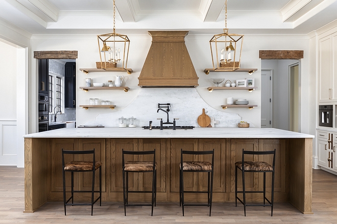 Kitchen with wood cabinet It would have felt too cold if we didn't bring in some of the wood elements. Even if we just did the wood toned island cabinetry, but didn't bother with the shelves, range hood, or reclaimed headers. However, by implementing all those elements it made for a warm and cozy kitchen out of one that could have gone the other way given it's vast scale #kitchenwoodcabinet #woodcabinet #woodenscabinet #kicthens #kitchens