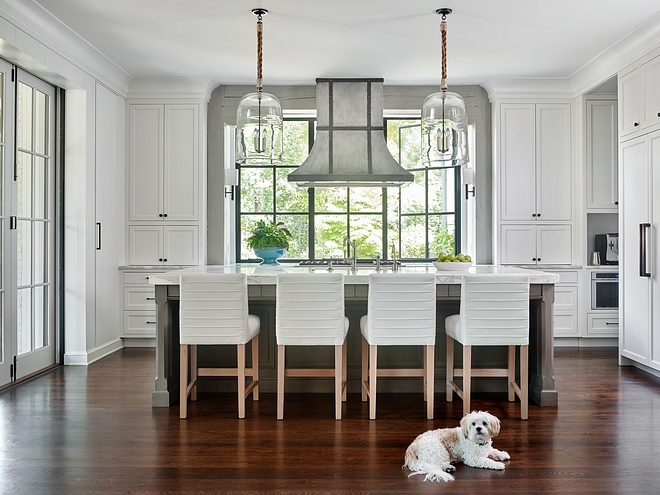Kitchen hood in front of window A custom varnished steel hood was placed right in front of the casement black steel windows. The beams framing the windows are custom lime-washed Timber #kitchen #Kitchenhood #window
