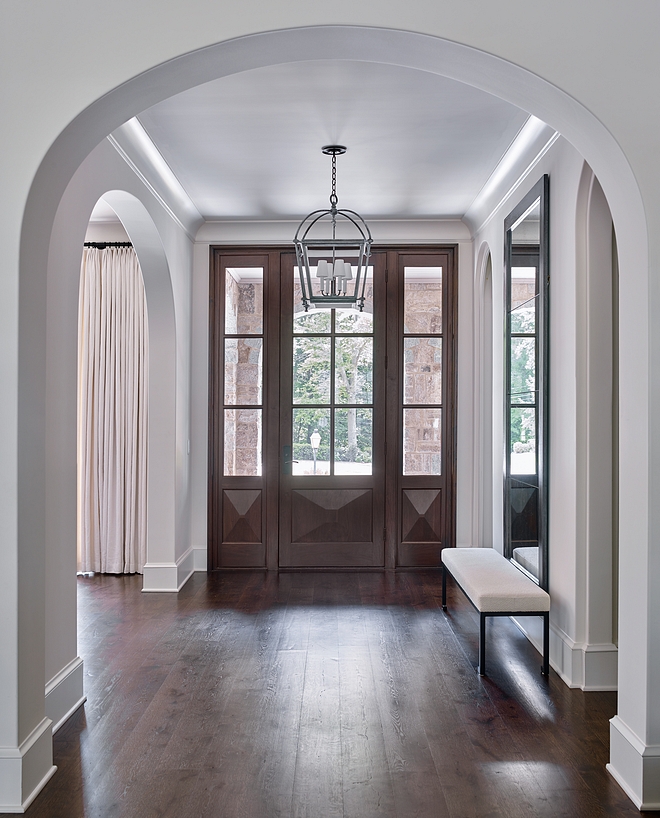 Foyer Featuring elliptical arches, medium-toned hardwood floors and a custom front door, this foyer is impressive and inviting at the same time #foyer #ellipticalarches #arch #hardwoodfloors #frontdoor