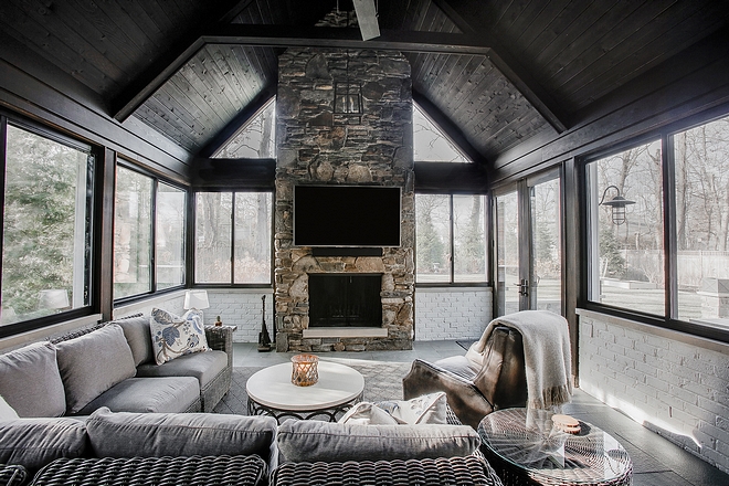 Four seasons room This inviting four seasons feature some incredible ideas! The stone used on the fireplace is Fieldstone #fourseasonsroom #fireplace #architecture