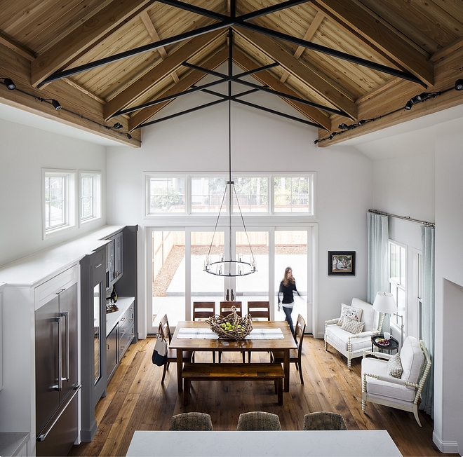 An impressive cathedral ceiling makes the kitchen and dining area feel extra spacious. Notice how the patio doors and transoms bring natural light into this room