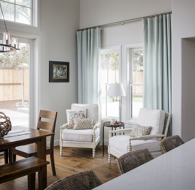 Sitting area with two chairs in kitchen by dining area This small sitting area is perfect to enjoy a cup of coffee in the morning #Kitchen #sittingarea #kitchens