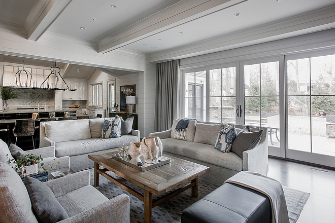 The dining area opens to a neutral yet warm living room. Notice the large patio doors leading to the backyard. #livingroom #openlayout #patiodoors