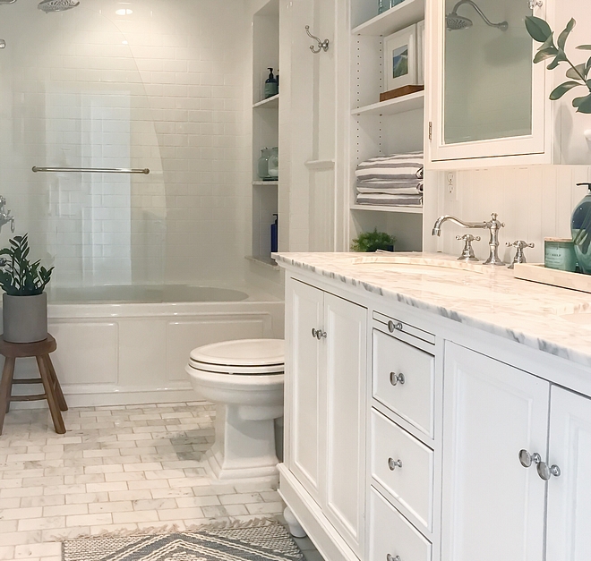 Bathroom with store bought vanity with carrara marble countertop and honed carrara marble subway tile used as flooring #bathroom #storeboughtvanity #vanity #carraramarble #marblesubwaytile #floortile #bathrooms