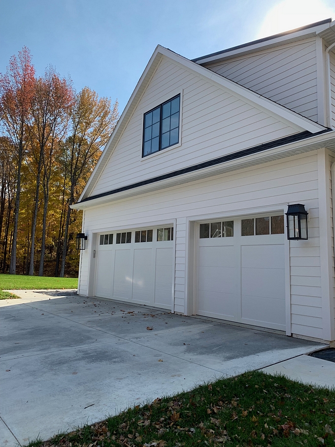 Garage Doors Coachman garage Doors with black metal windows, white siding and black outdoor sconces Garage Doors Coachman Garage Doors Coachman #GarageDoors #Coachman #Coachmangaragedoor #garagedoor #whitesiding #blackwindows #whitehomes #outdoorsconces #blacksconces #garage