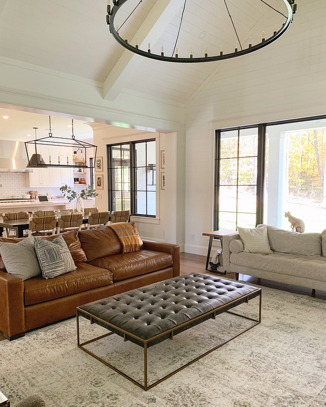 Living room decor It’s really important for me to bring in lots of textures to create a cozy space. We added hickory shelves in the built ins, caramel leather couch, grey treed chairs, a black and brass ottoman, chrome hardware, striped linen pillows. I’m a big fan of mixing metals as well as materials #livingroom #decor #leathercouch #caramelleather