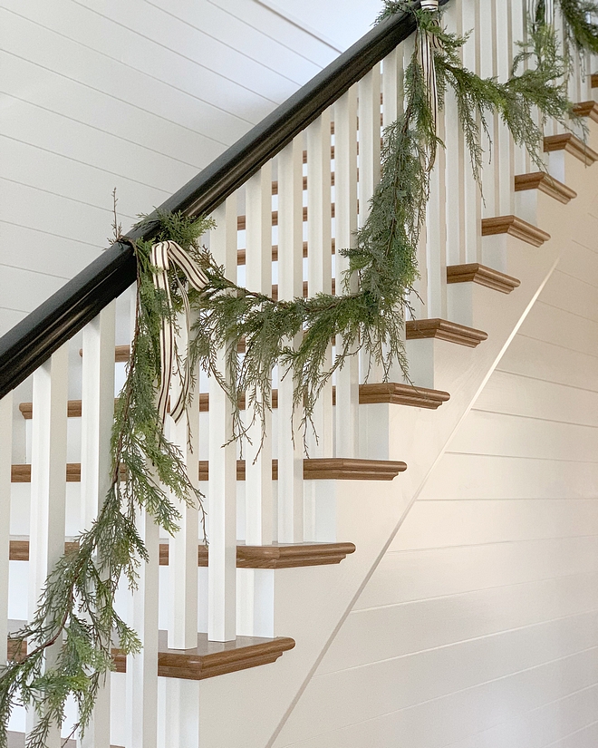 Staircase Upon walking into our home, you are greeted with a traditional staircase with black glossy railing and shiplap walls painted in Benjamin Moore Chantilly Lace #staircase #blackrailing #shiplap #shiplapwall #BenjaminMooreChantillyLace