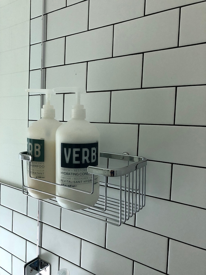 Shower with matte white subway tile and black grout