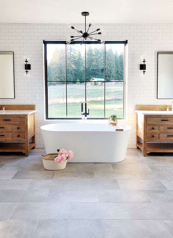 Farmhouse bathroom with black windows, freestanding tub between Oak vanities #farmhouse #farmhousebathroom #blackwindow #oakvanities #oakvanity #farmhosue #farmhousestyle #modernfarmhouse