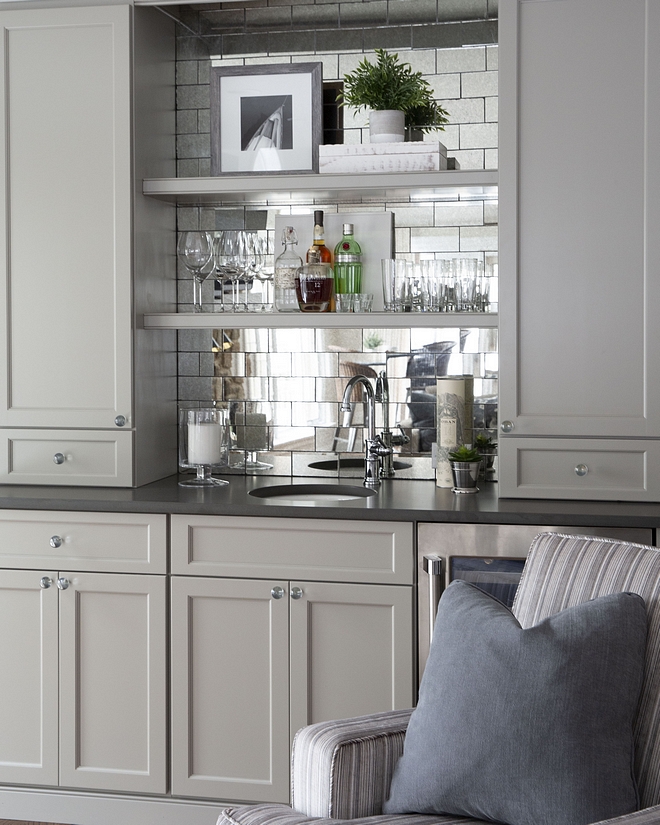 Benjamin Moore Hearthstone The bar cabinet is painted in Benjamin Moore Hearthstone and it features antique mirror glass subway tile and honed Alleanza Gotham Grey quartz countertop Benjamin Moore Hearthstone #BenjaminMooreHearthstone