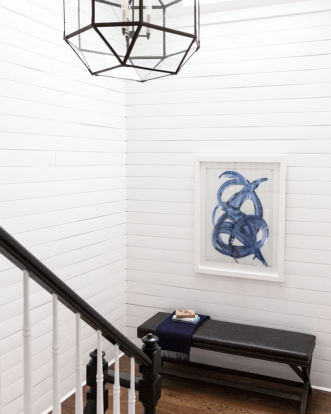 Staircase renovation The newly-painted staircase features white shiplap and a new lighting fixture Staircase reno #staircasereno #staircase #renovation