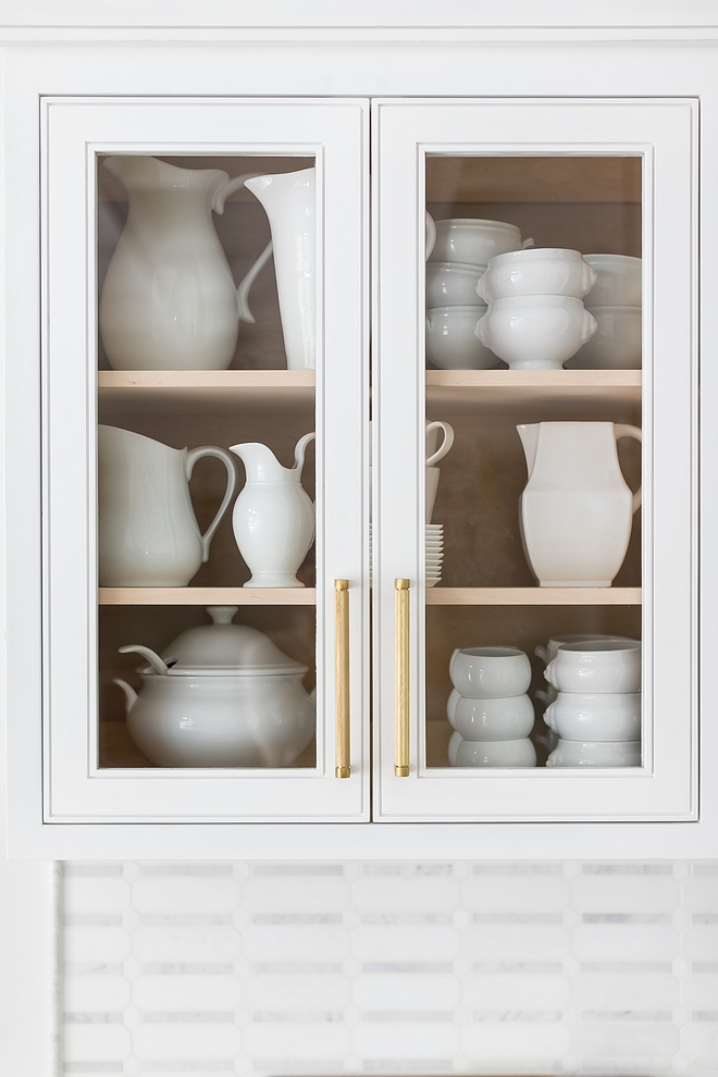 Glass doors were placed only on this cabinet and I am a big fan! Less glass, less time spent cleaning them Jokes apart, notice the beautiful door details Also, placing only white dinneware accentuates the Maple cabinetry #kitchen #cabinet #glassdoors #cabinetglassdoor #cabinetstyle