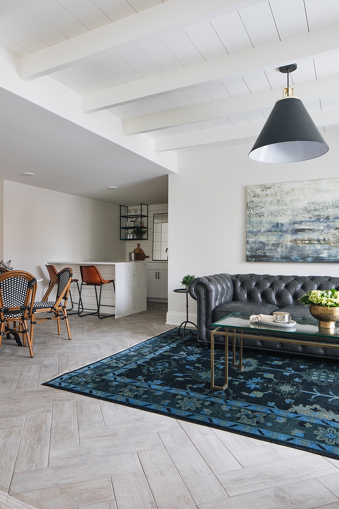 This basement is full of great ideas. I love the beamed tongue and groove ceiling and the herringbone wood-looking floor tile #ceiling #basement #woodlookingtile #herringbonetile