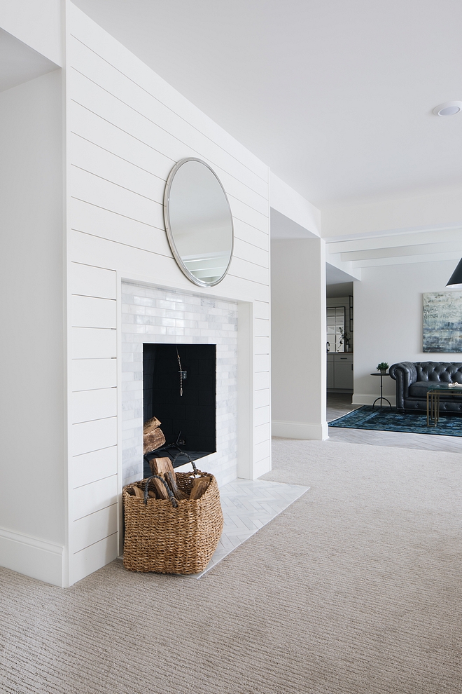 Without a mantel, the fireplace was kept simple, only featuring with shiplap and white marble tile, both in brick and herringbone patterns #fireplace #shiplap