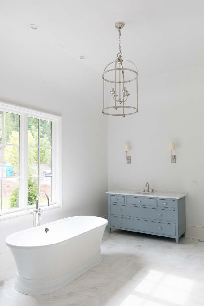 Bathroom with blue gray vanity walls are Sherwin Williams Snowbound #bathroom #masterbathroom #bluevanity #bluegray #SherwinWilliamsSnowbound