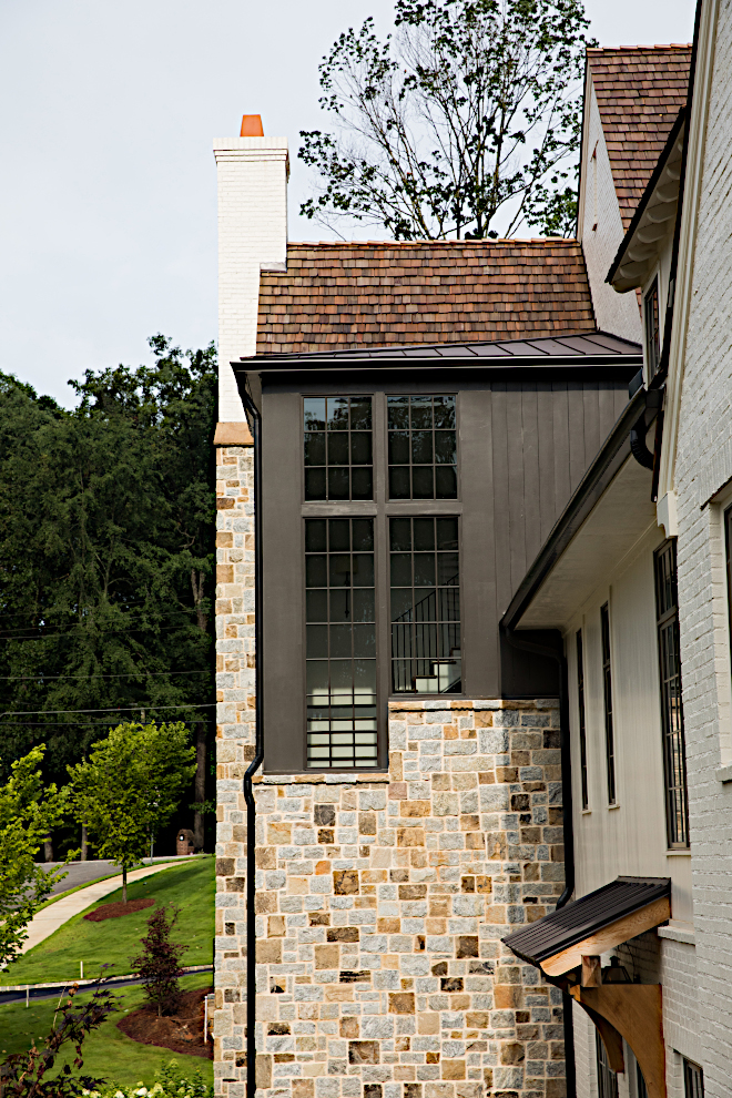 Exterior stone black metal windows View of staircase tower from outside #Exterior #stone #blackwindows #metalwindows #staircasetower #tower