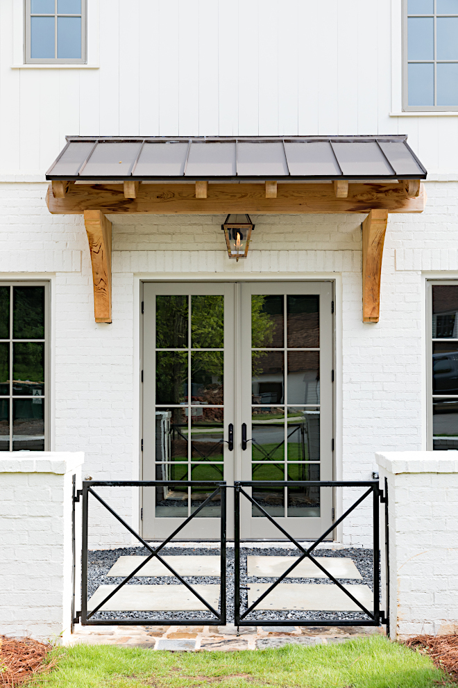 Grey metal front door The grey doors are painted in Sherwin Williams SW 7016 Mindful Gray with Benjamin Moore OC-13 Soft Chamois brick exterior paint color #Greydoor #greyfrontdoor #paintcolor #metalfrontdoor#SherwinWilliamsSW7016MindfulGray