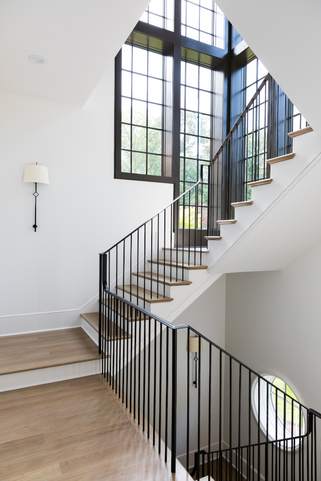 Metal railing spindles staircase The stunning staircase features custom iron railings, hardwood threads and black steel windows #ironrailings #ironstaircase #metalstaircase #blacksteelwindows #Metalrailing #metalspindles #staircase