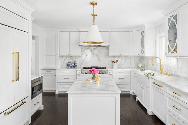 Classic white kitchen with white marble countertop white marble slab backsplash white cabinets white kitchen island and dark hardwood flooring #whitekitchen #whitekitchenisland #whitemarble