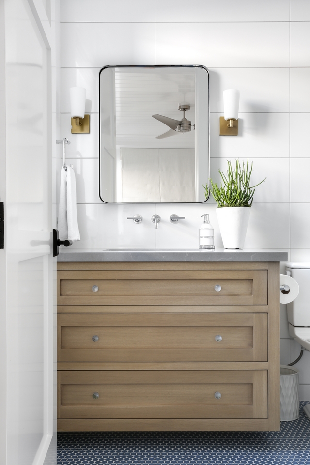 Bathroom featuring blue penny tiled floors, shiplap tiled walls and the Rough Sawn White Oak vanity #bathroom #bluepennytile #tiledfloors #shiplaptile #RoughSawnWhiteOak #vanity