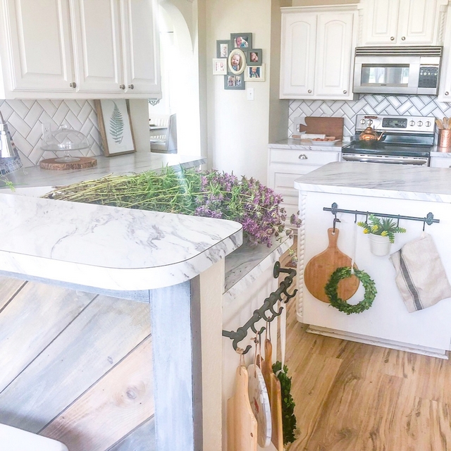 The kitchen countertops are laminate in "Carrera marble"