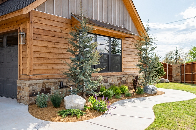 The home exterior features gray stained board and batten, Cedar siding and reclaimed barnwood That's how a real farmhouse is made of! #homeexterior #stainedboardandbatten #Cedarsiding #reclaimedbarnwood