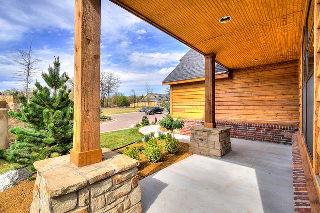 The porch columns feature Timber posts and natural stone. Red brick was added on the foundation wall #porchcolumns #Timberposts #naturalstone #Redbrick #brickfoundationwall #foundationwall