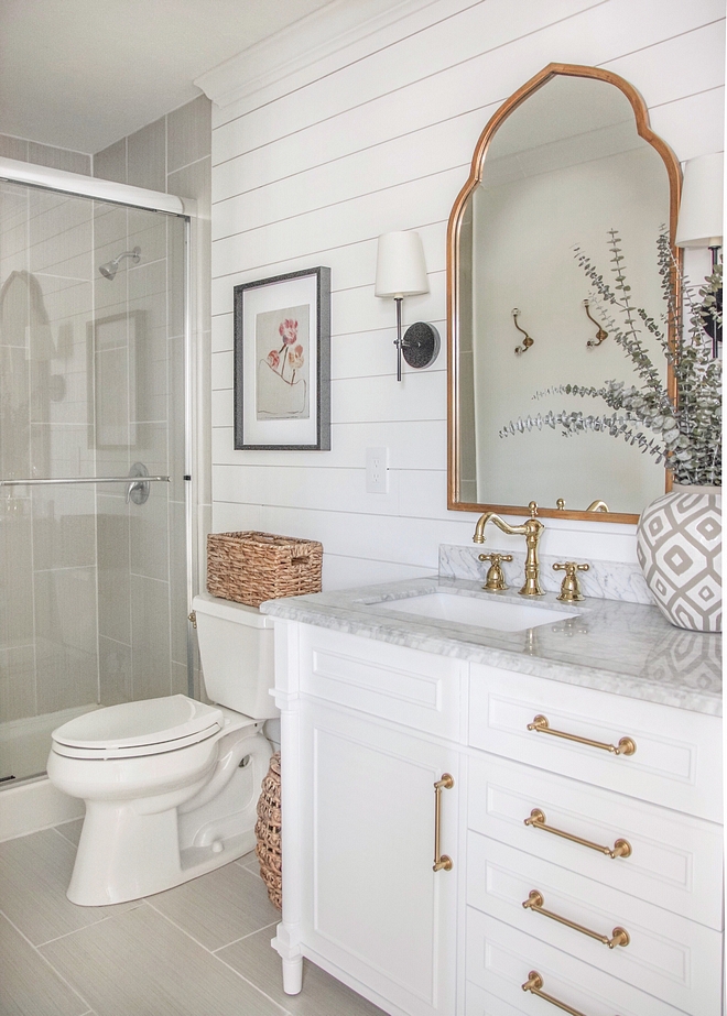 Shiplap Bathroom Reno I painted everything white and brought in more dimension with the shiplap wall, and changed out the overhead vanity light for three sconces surrounding the arched brass mirrors Shiplap Bathroom Reno Shiplap Bathroom Reno #Shiplap #BathroomReno #shiplapBathroomReno