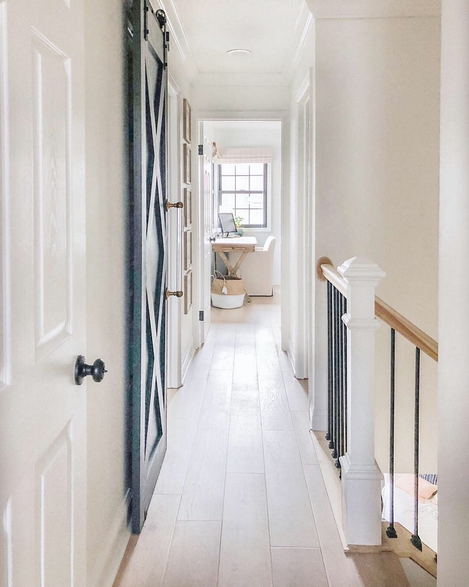 This hallway is one of my favorite transformations in the home. Previously there was a view of the half wall going up the second staircase and part of the hallway, which is now wrought iron spindles #hallway #home #staircase #wroughtironspindles