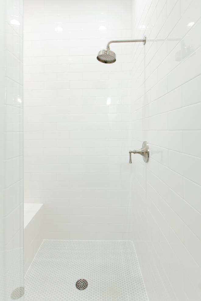 Simple Shower Tile Ideas The shower is now much larger and wrapped in beautiful white tile. I chose the light gray penny tile to add a touch of color and the penny tiles feel so soothing on your feet #showertile #largesubwaytile #tile #shower