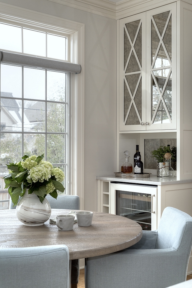 Kitchen Bar Small Kitchen Bar Cabinet Previously the corner of the kitchen housed a tiny desk and became a catchall for a little bit of everything. They knew they could turn it into a much more usable and beautiful space. Now it is an entertaining-workhorse – with antique-mirrored upper cabinetry and a beverage refrigerator and wine rack below #kitchencabinet #cabinet #bar