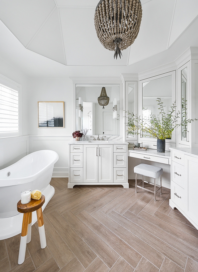 Wood-looking tile One of our preferences when doing bright white spaces is to bring in a warm element. We could have easily done a light floor – white or gray marble, and it would have been beautiful, but maybe a little cold – and certainly not as cozy feeling. Amy approached our client about doing a wood-look tile in a herringbone pattern for the floors #woodlookingtile #tile #bathroomtile