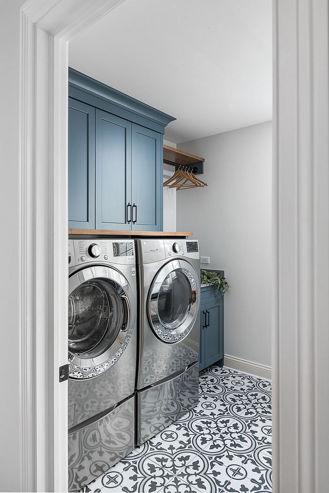 Laundry room renovation The cabinets were painted this lovely custom shade and given new doors and hardware. And in a room like a laundry room, why not go fun and bold with the flooring? We selected this tile that mimics the look of more expensive cement tiles #laundryroom #renovation #cabinet #paintingcabinets #cementtile