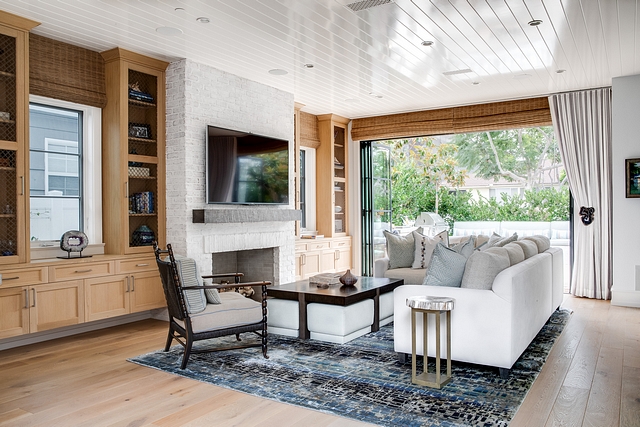 Living room with Limewashed fireplace flanked by Rift White Oak Cabinets #Livingroom #Limewashed #fireplace #RiftWhiteOak #Cabinet