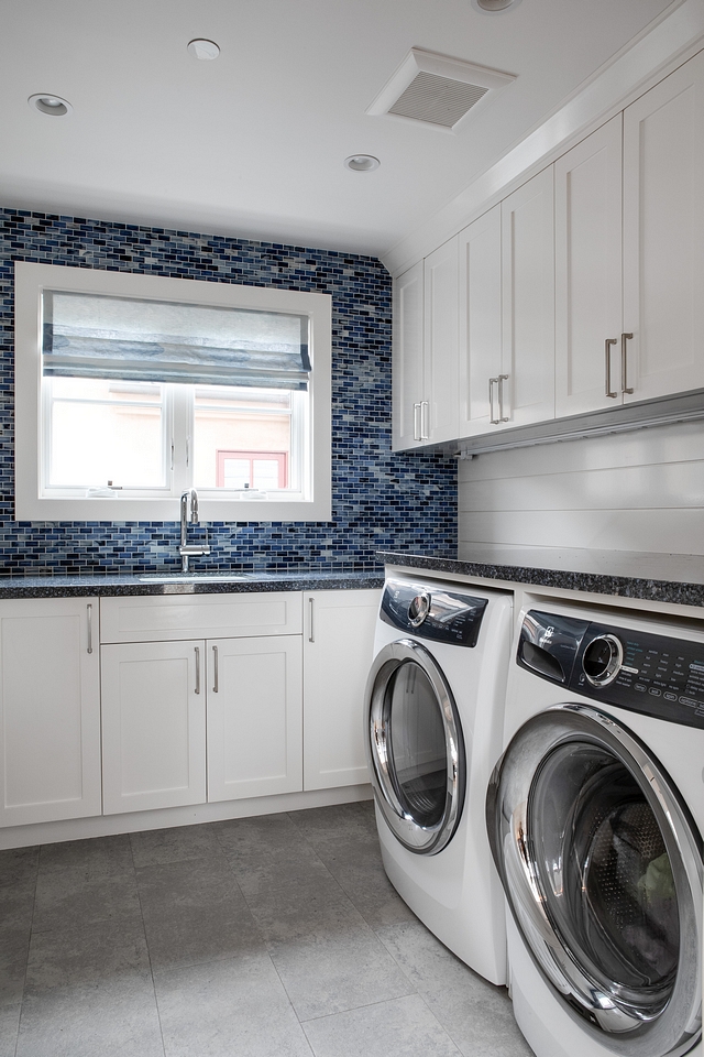 Laundry room This spacious laundry room features shaker style cabinets, painted in Benjamin Moore OC-145 Atrium White, and a mix of shiplap and mosaic backsplash tile Laundry room cabinet white paint color #Laundryroom #shakerstylecabinet #BenjaminMooreOC145AtriumWhite #BenjaminMooreAtriumWhite #BenjaminMooreOC145