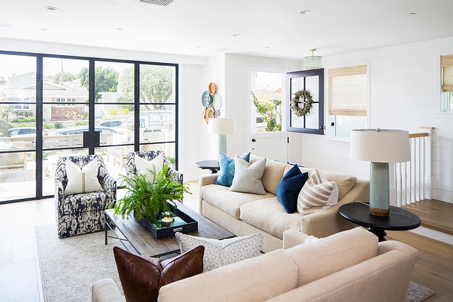 Living room Continuing the builder's balance of clean, modern design and eclectic finishes, the designer brought in staples such as neutral sofas and reclaimed furnishings while incorporating patterns with a bohemian flair and earthy-tone accents #livingroom #decor #interiordesign