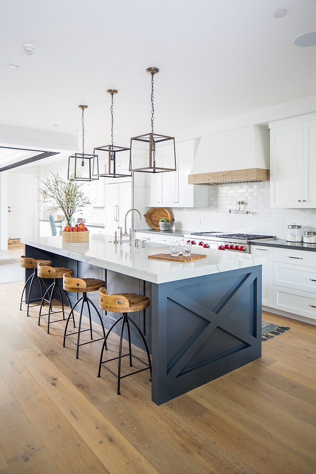 Blue kitchen island with x ends kitchen island We added an “X” detail to the kitchen island to add a little spark to the simplicity of the shaker cabinets. We also introduced a reclaimed wood band on the custom range hood to compliment the ceiling detail in the adjacent dining room The kitchen Island was painted Benjamin Moore Deep Space 2125-20 #Bluekitchenisland #xkitchenisland #kitchenislandends #kitchenisland